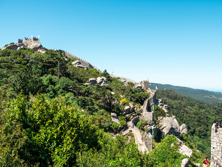 Aerial view of the Castle of the Moors tower wall amid trees.