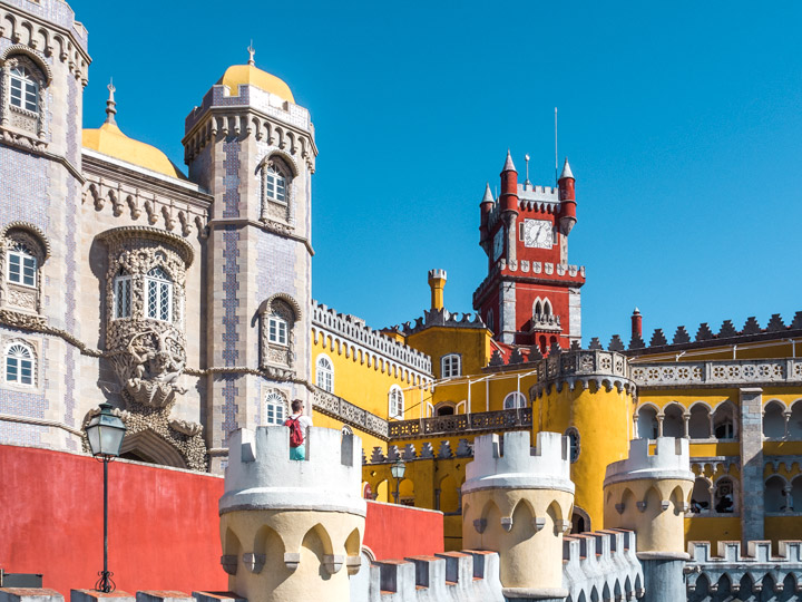 1 Day Sintra Itinerary - view of red and yellow Pena Palace walls and clock tower.