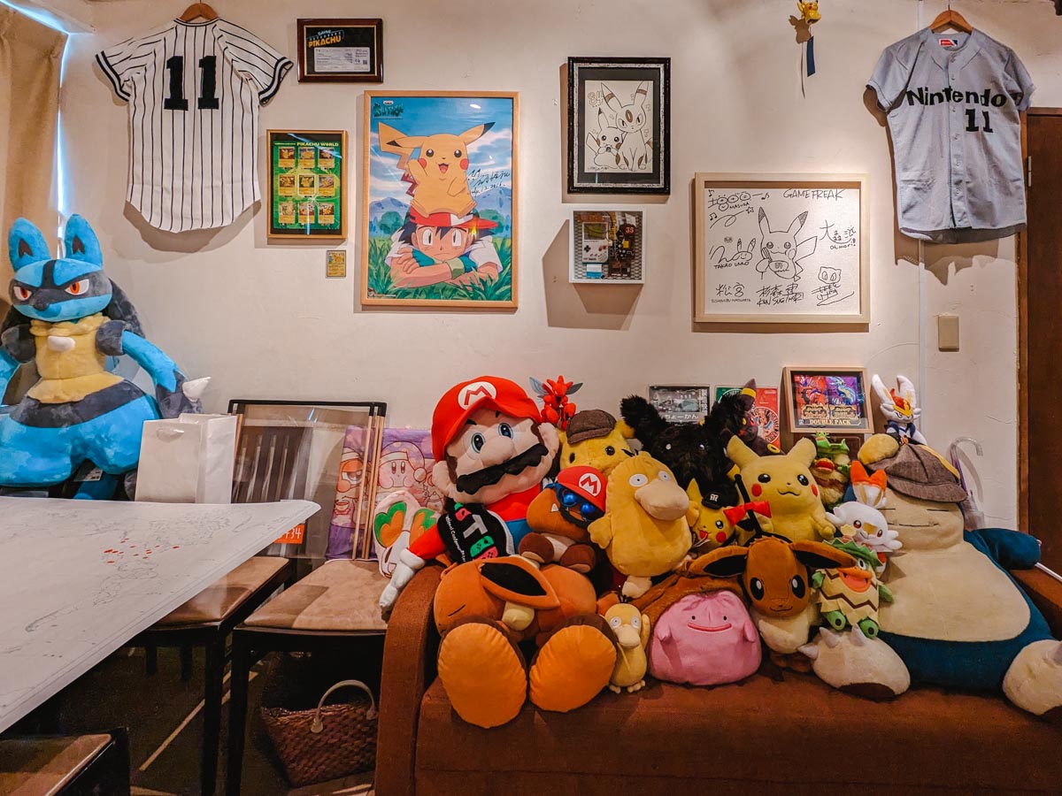 Inside 84 Cafe Secret Nintendo Bar with various plushies and artwork.