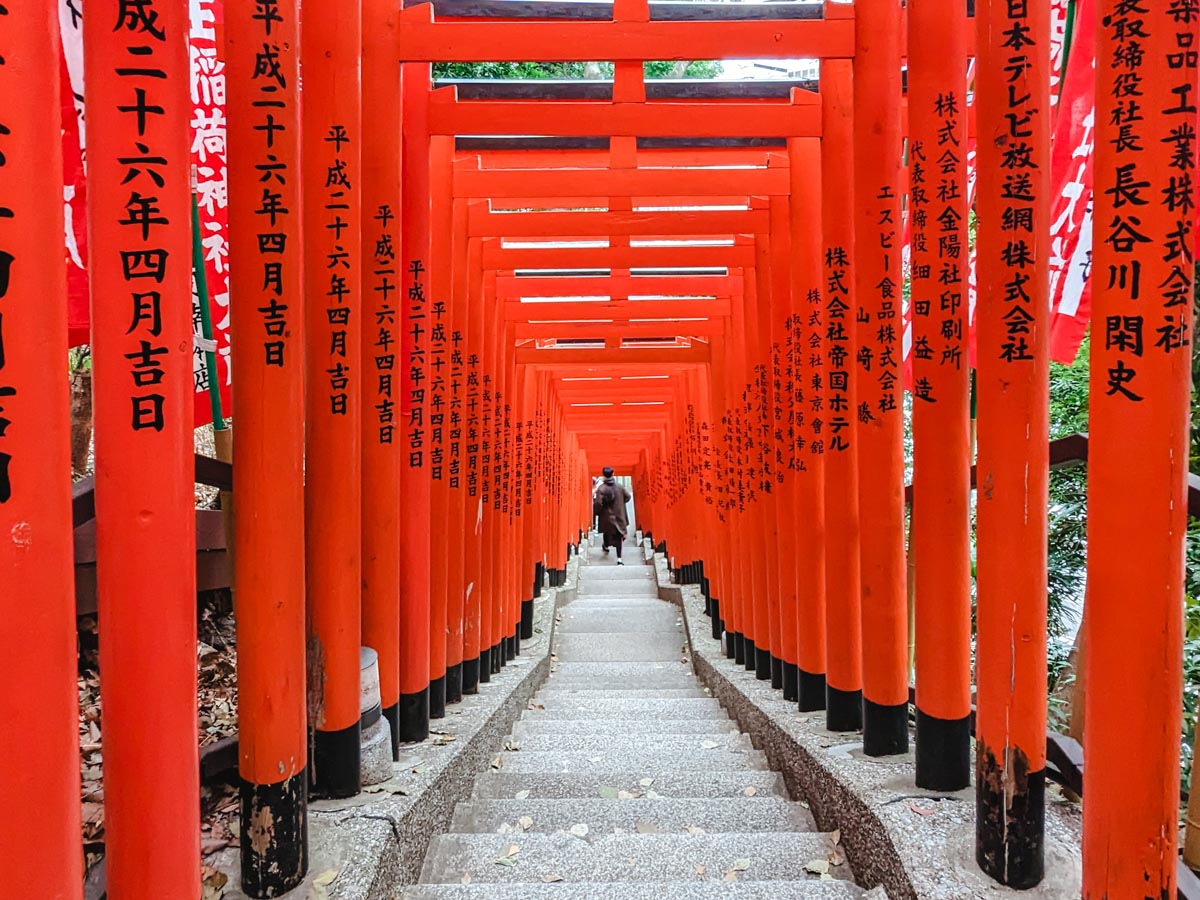 Long staircase lined with vermillion torii gates at Hie Shrine.