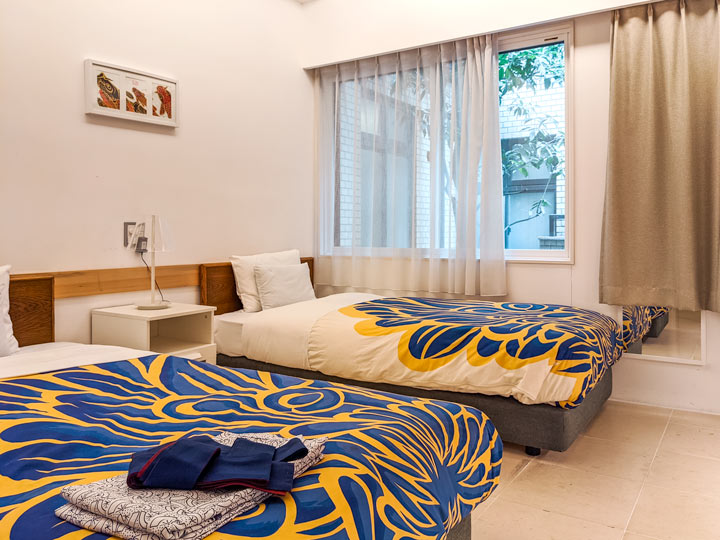 Kyoto Traveler's Inn western style hotel room with blue and white floral bedding.