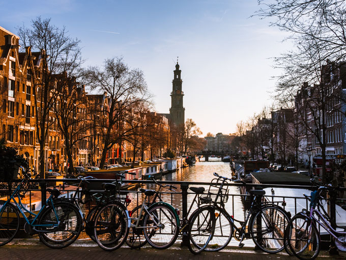 The 9 Streets at sunset with bicycles lining bridge.