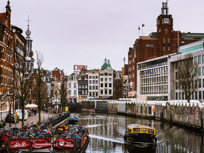 View of Amsterdam Bloemenmarkt with yellow boat.