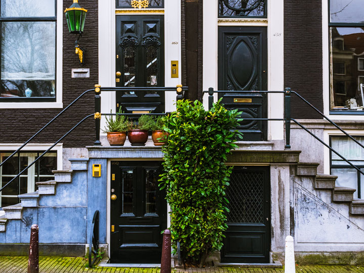 Two house facades with four doors and staircases seen during 2 days in Amsterdam itinerary.