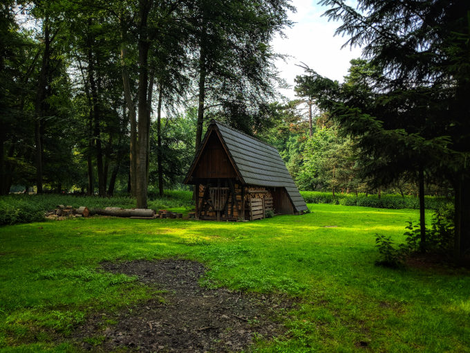 Wood cabin inside Stadtwald park green field.