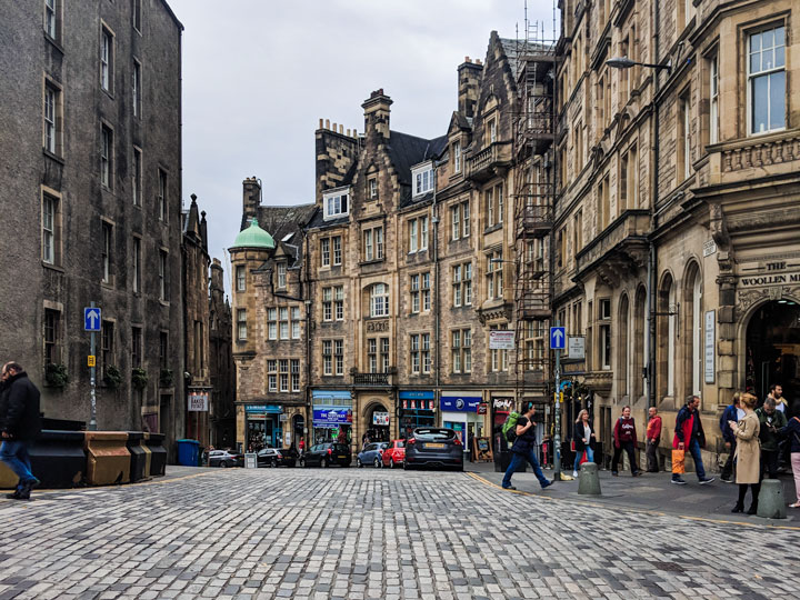 Street view of stone buildings and crosswalk in Edinburgh