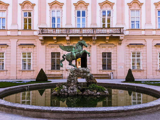 Mirabell Gardens Pegasus Fountain in front of Mirabell Palace windows.