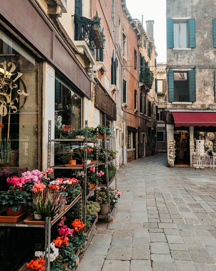 Flower ship and alley in Venice Campo San Cassiano.