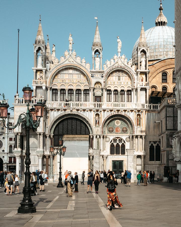 Exterior of St. Mark's Basilica and the Doge's Palace on a busy morning.