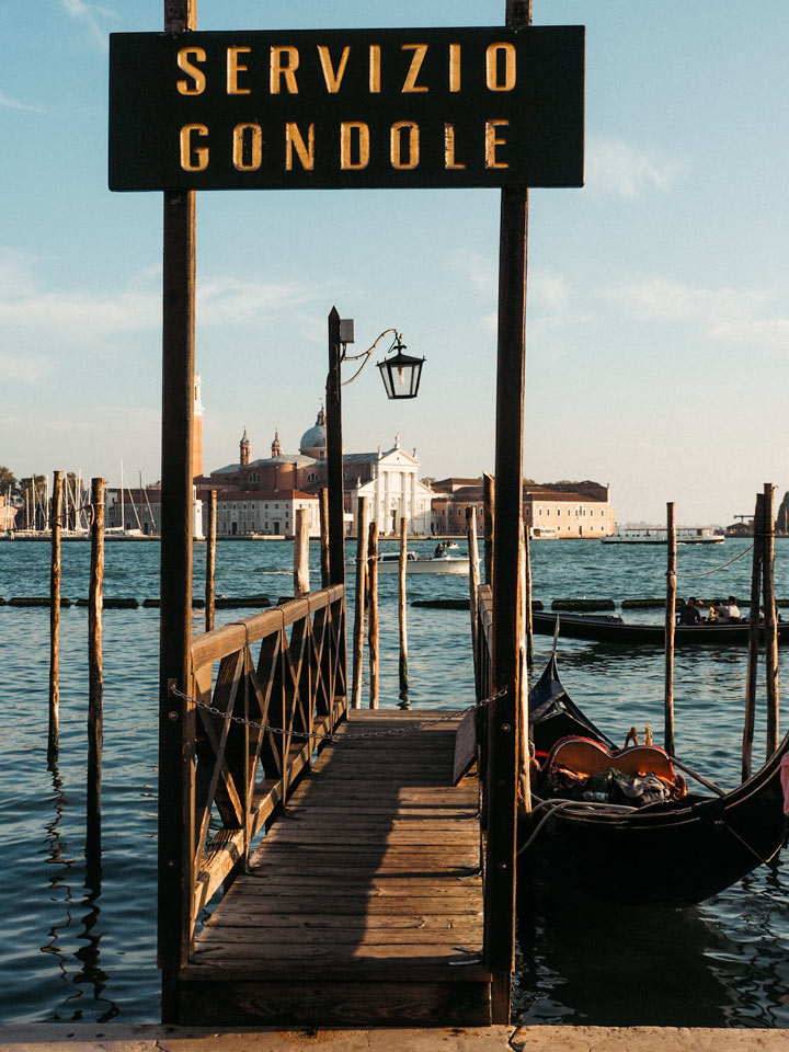 Gondola service pier with docked boat and view of San Giorgio Maggiore.