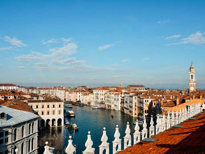 T Fondaco dei Tedeschi terrace view over Venice canal and buildings.