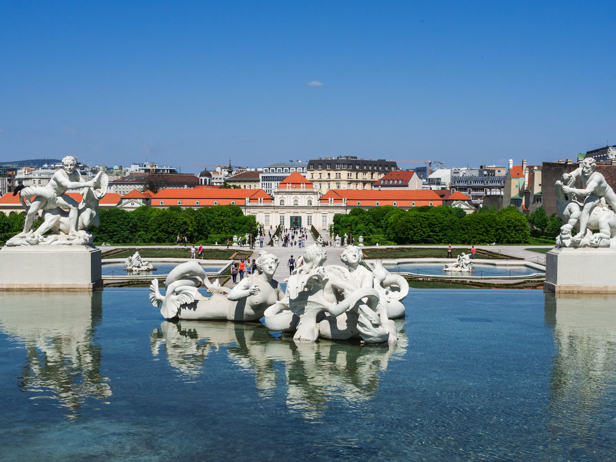 Fountains with statues in front of palace walkway seen during 2 day Vienna itinerary.