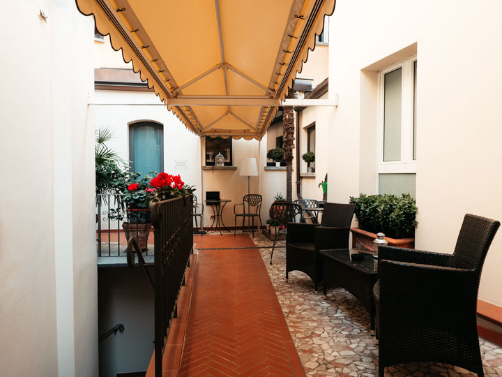 Hotel Touring Bologna terrace with patio furniture and orange covered walkway