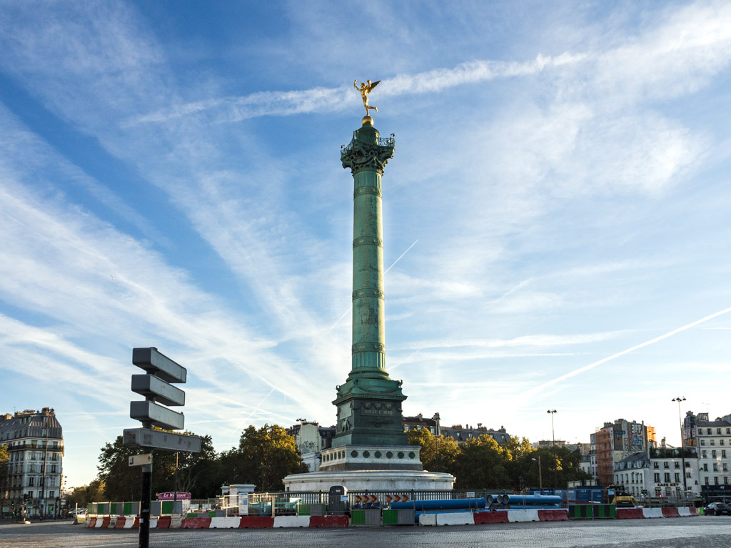 Bastille July Column against blue sky with streaky clouds.