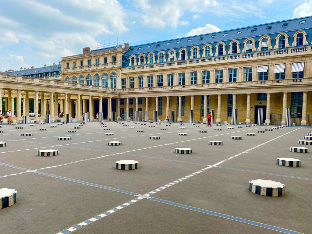 Interior courtyard of Paris Palais Royal with black and white striped columns.