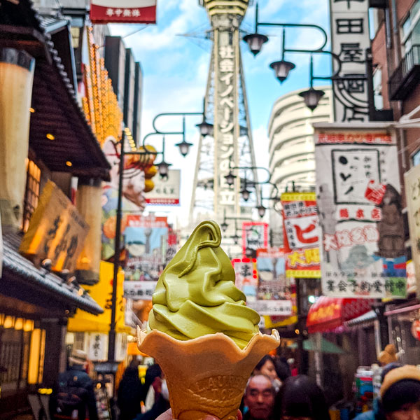 Matcha ice cream held on busy Osaka Japan street