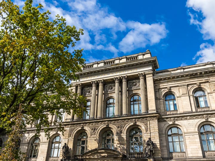 Facade of Berlin Museum of Natural History with partly cloudy sky.