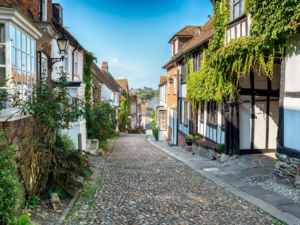 Cobbled street lined with old timbered houses in Rye UK.