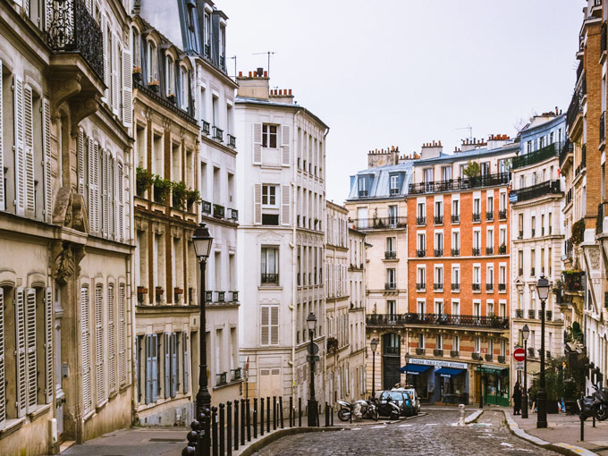 Hilly street in Paris lined with traditional flats