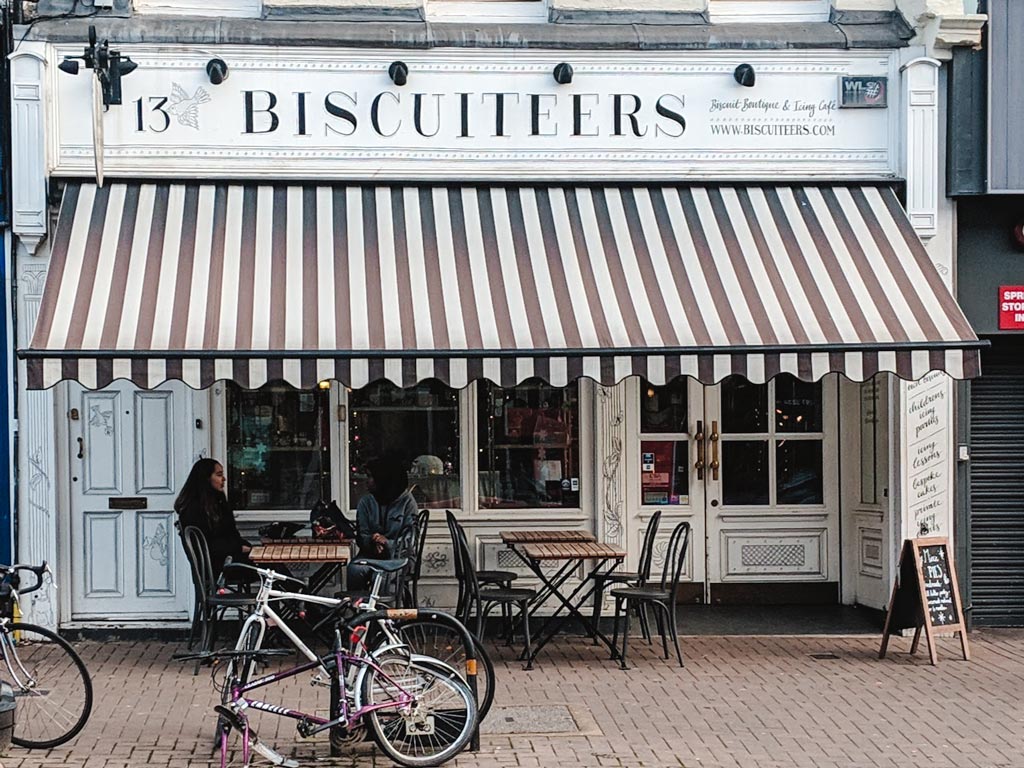 Exterior of Biscuiteers shop in London with black and white striped awning.