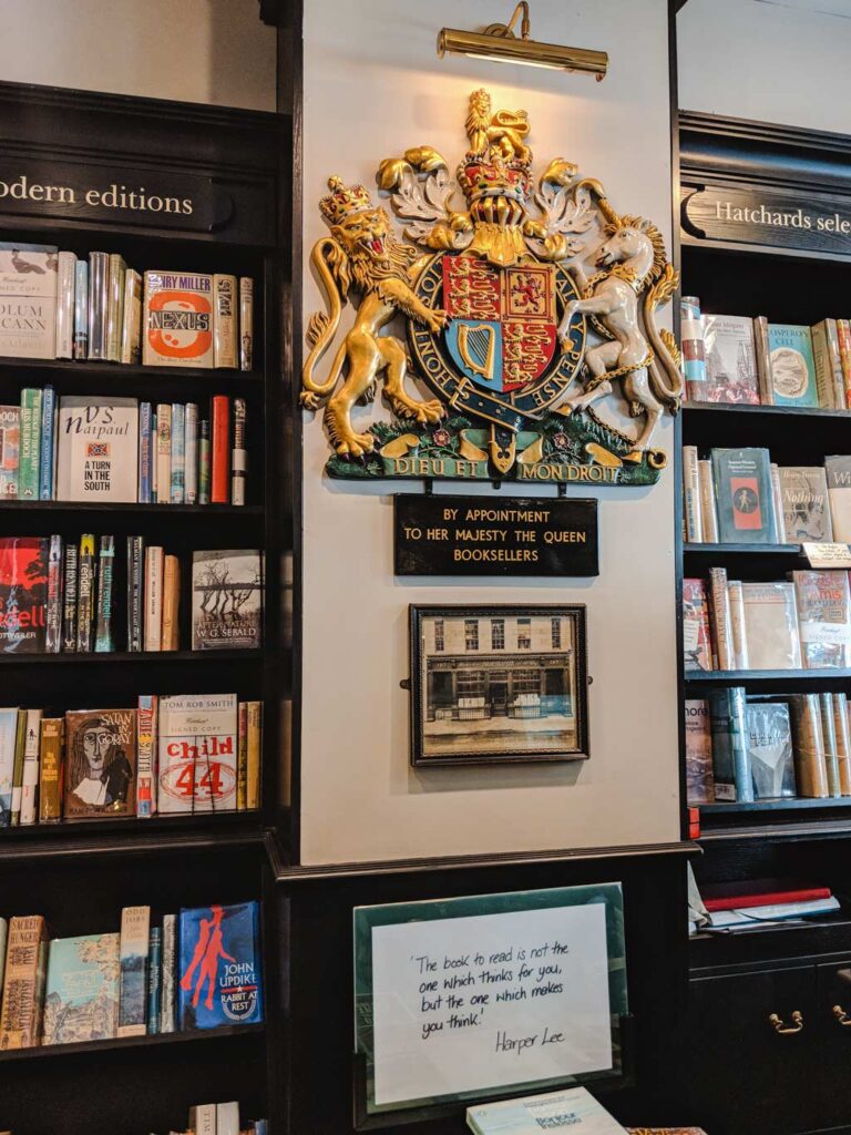 Interior of Hatchards bookshop in London with Royal Warrant seal on wall.