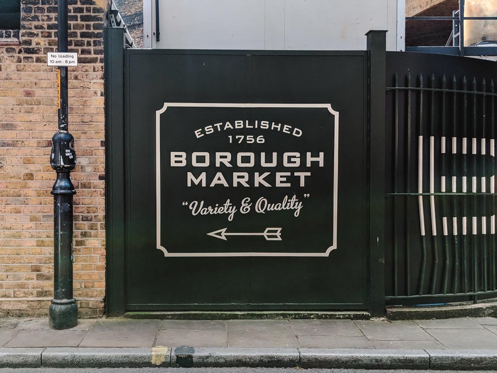 Sign outside Borough Market with arrow pointing the way left.