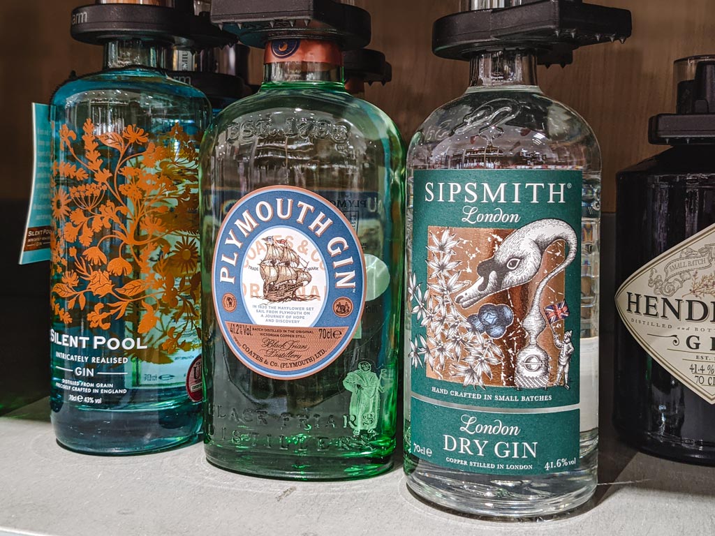 Three bottles of English gin: Sipsmith, Plymouth, and Silent Pool.