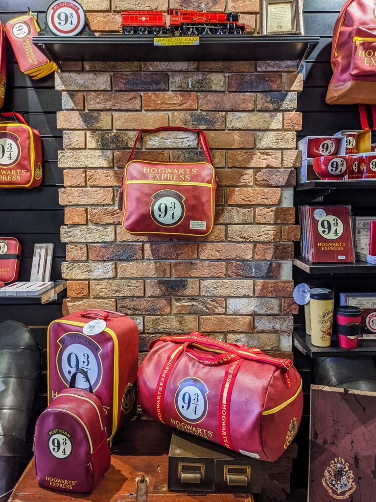 Display of Harry Potter stuff in London shop House of Spells, including duffel bags and mugs.