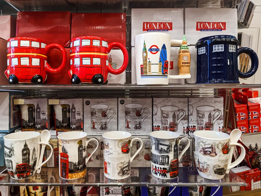 Shelves with London themed mugs including red bus and phone box.