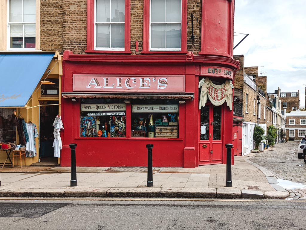 Red exterior of Alice's antique shop and Portobello Road market.