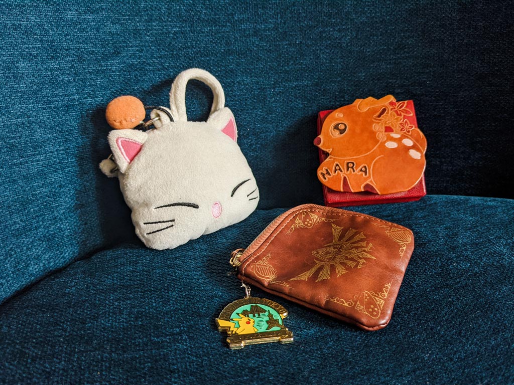 Moogle head coin purse, deer coin purse, and leather coin purse with Hyrule symbol on front.