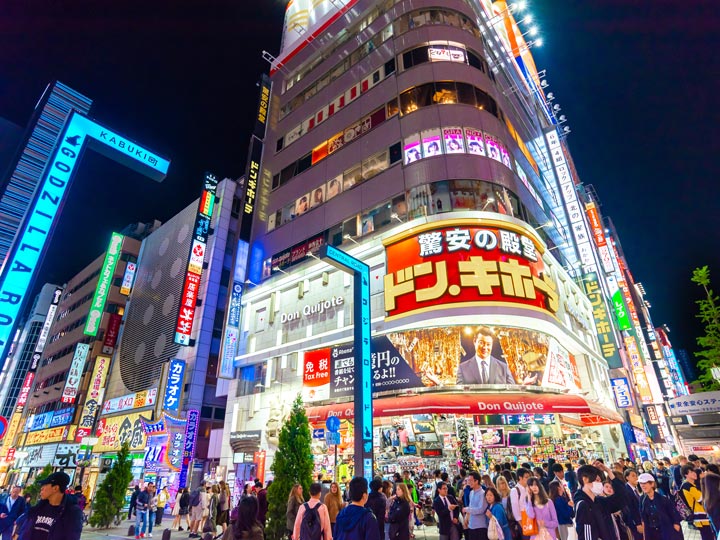 Exterior of Don Quijote building at night in Tokyo.