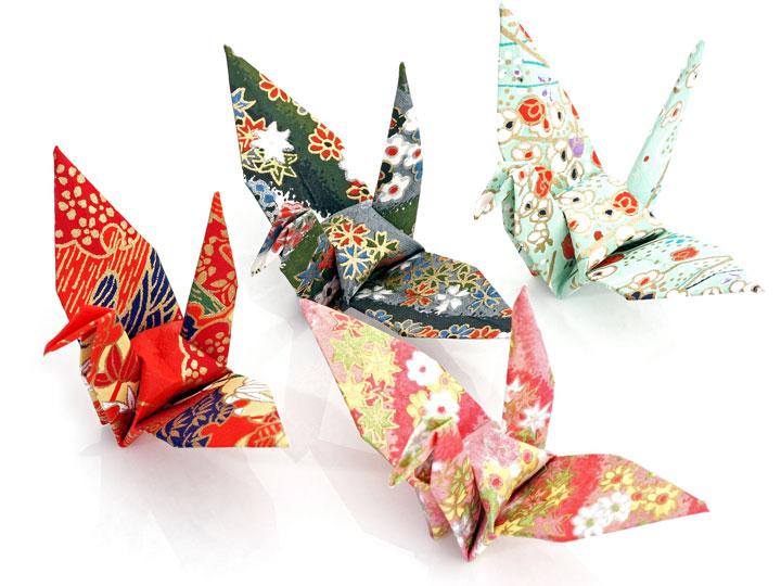 Red, white, and green origami paper cranes.