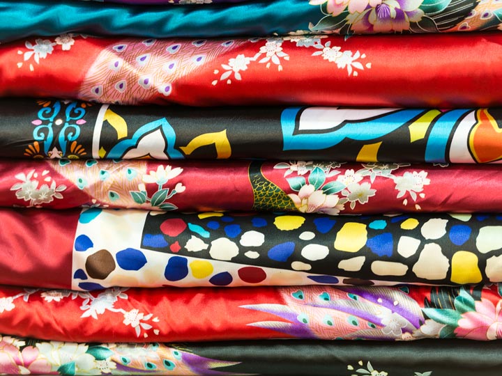 Layers of colorful silk fabric with various prints.