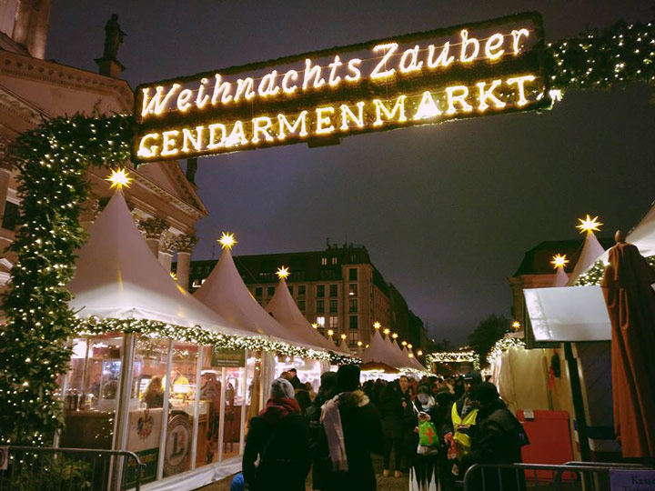 Berlin Christmas Market entrance illuminated at night, among the best European cities to visit in December.