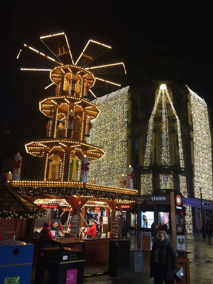 Illuminated ride and shopfront in Glasgow at Christmas.