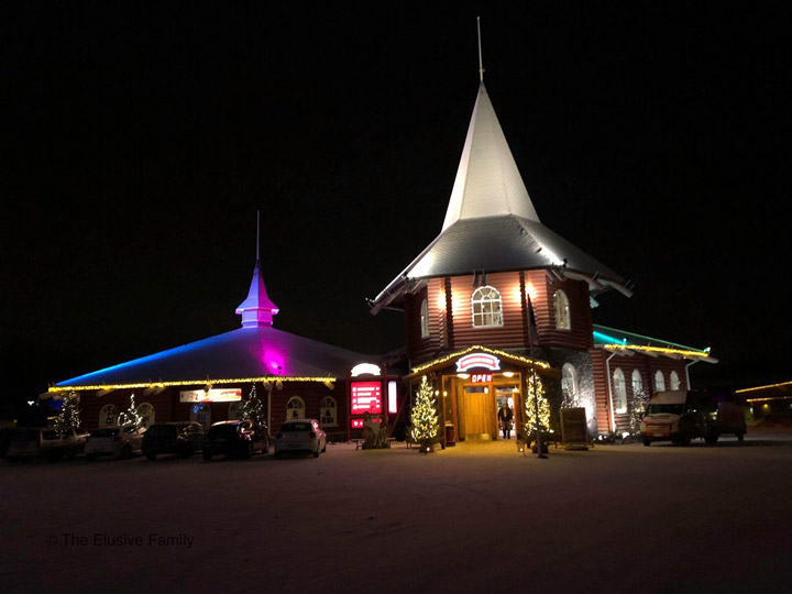 Winter chalet illuminated against night sky in Rovaniemi.