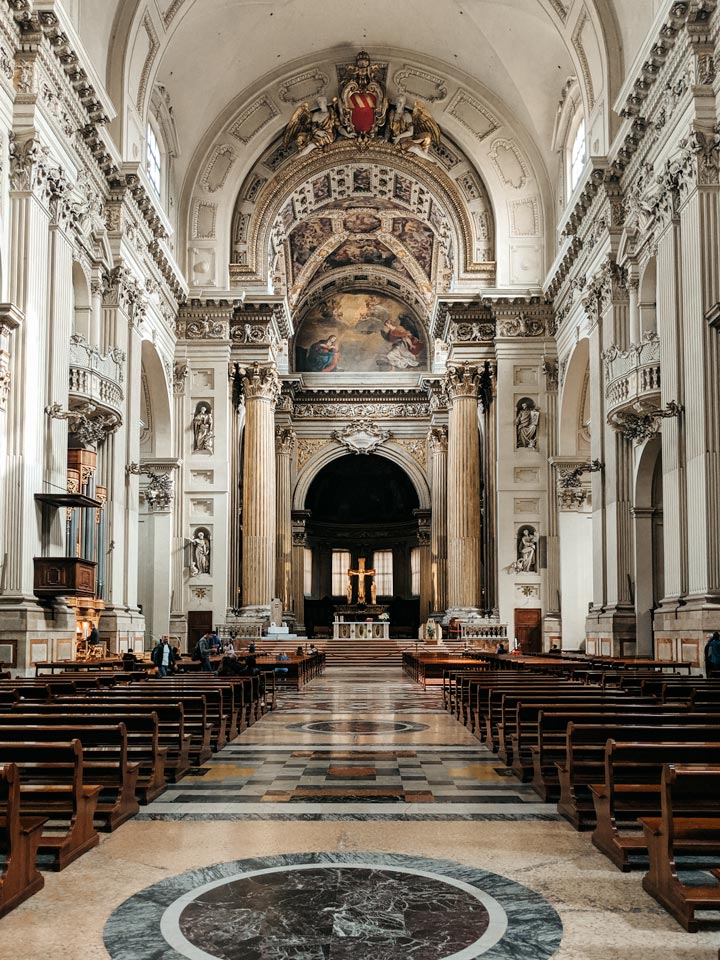 White marble interior and nave of Bologna Metropolitan Cathedral.