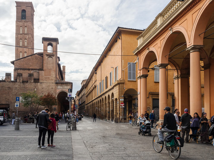 University of Bologna campus with students walking and cycling.