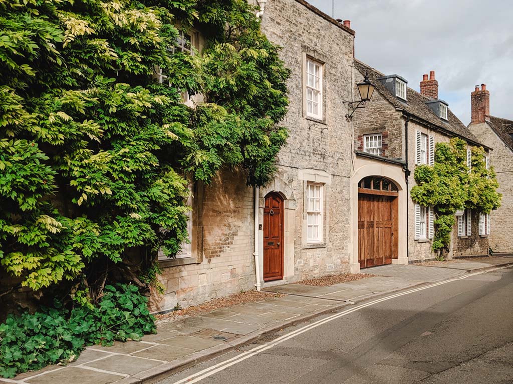 Street of old British houses built with stone.