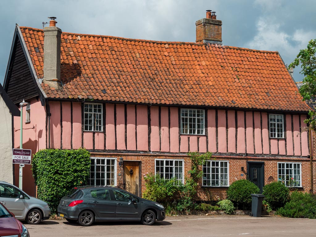 Historic pink English cottage house for sale.