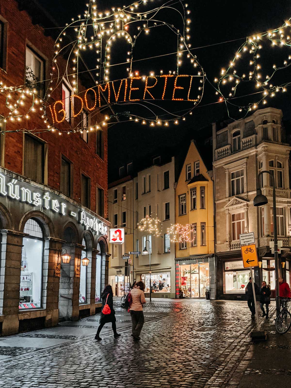 Aachen old town street at night with Christmas market illumination.