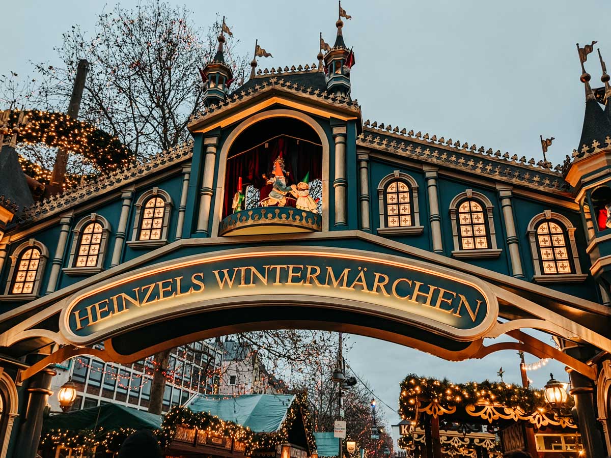 Entrance to traditional German Christmas market itinerary location in Cologne, with text "Heinzels Wintermarchen".