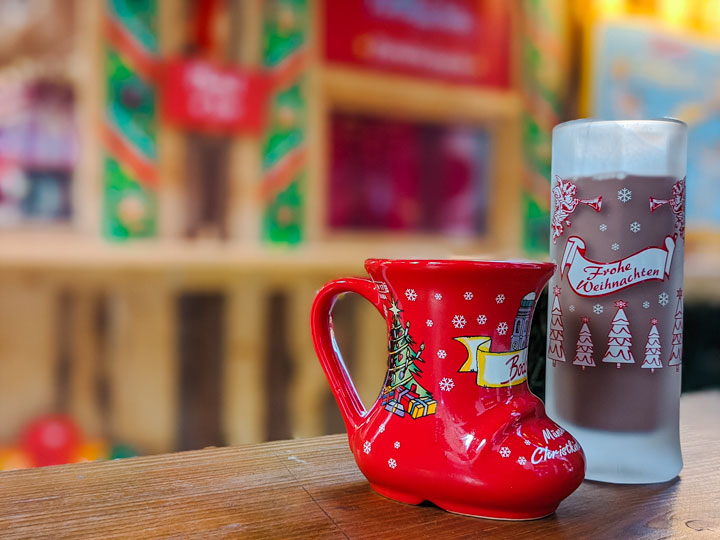 Red boot and tall frosted mugs at Munich Christmas market.