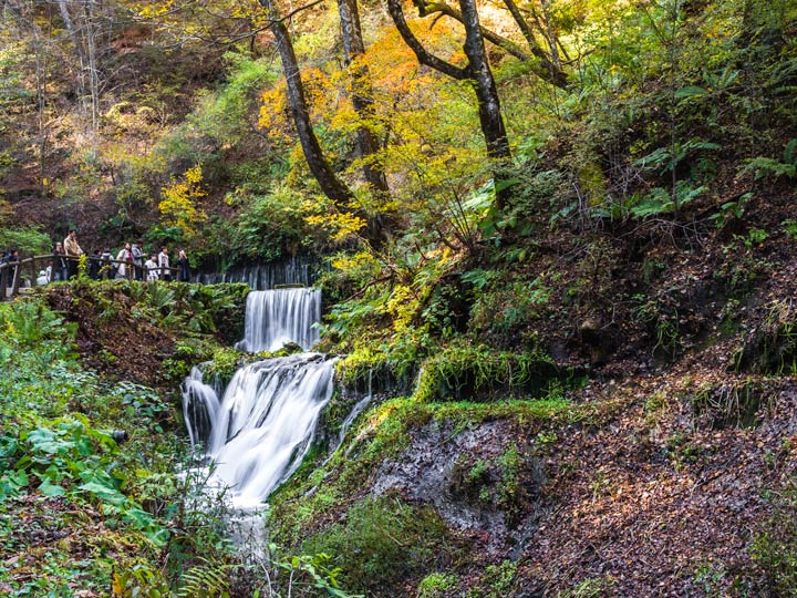 Shiraito Falls stream with autumn leaves in Karuizawa Japan.