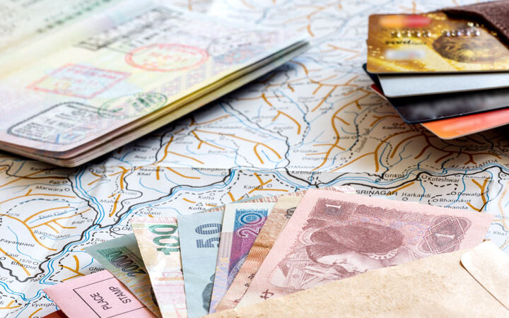 Living in a foreign country passport, currency, bank cards, and map flat lay