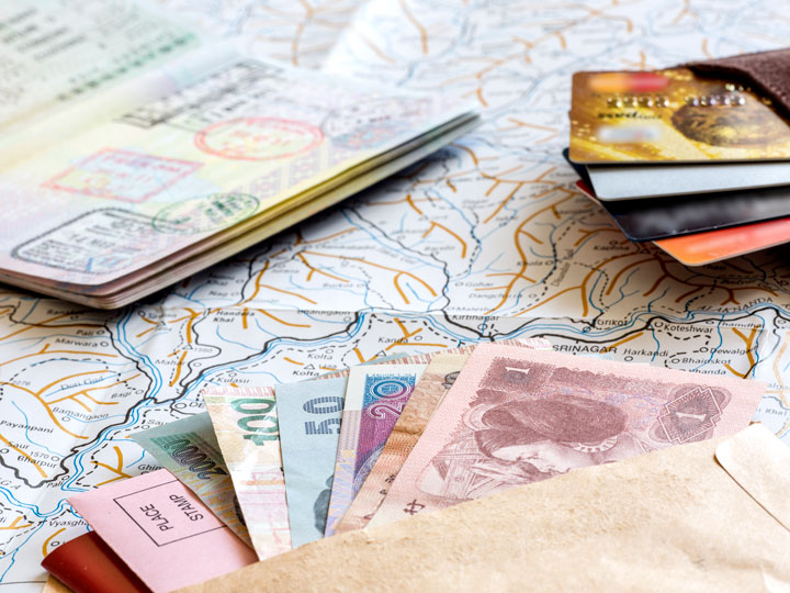 Living in a foreign country passport, currency, bank cards, and map flat lay.