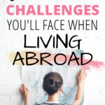 9 common challenges you'll face when living abroad - girl holding map against white wall