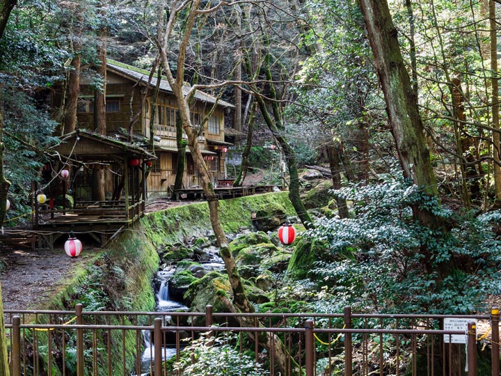 Wooden cabin in forest next to stream in Otsu.