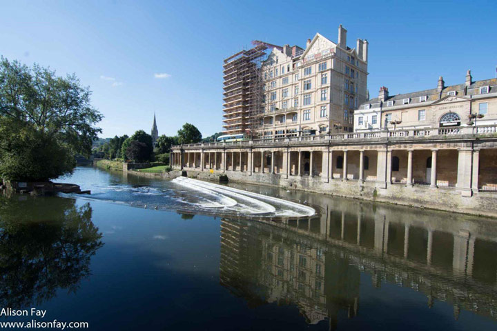 View of Roman Bath building along riverfront.